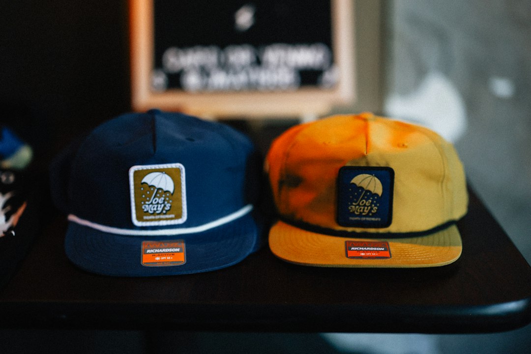 Two caps sit side by side, showcasing their patches